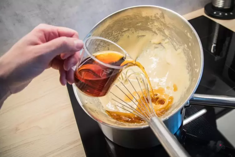 A woman pours Marsala wine into a bowl