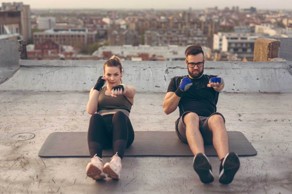 Couple doing punch crunches exercise