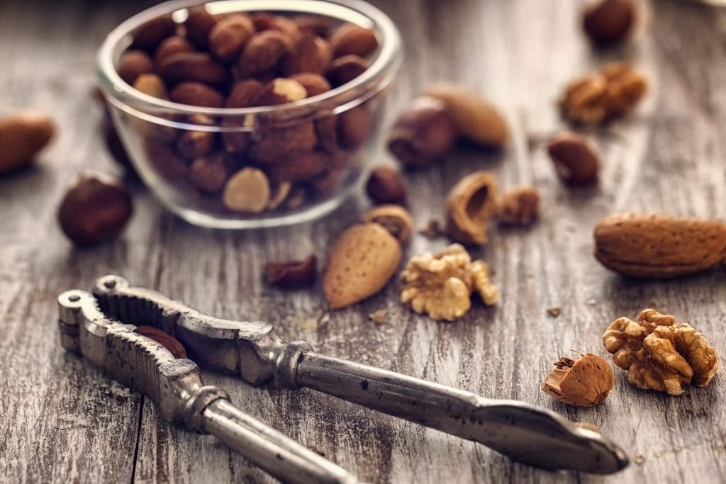 High-fiber foods: Nuts in a jar with nutcracker