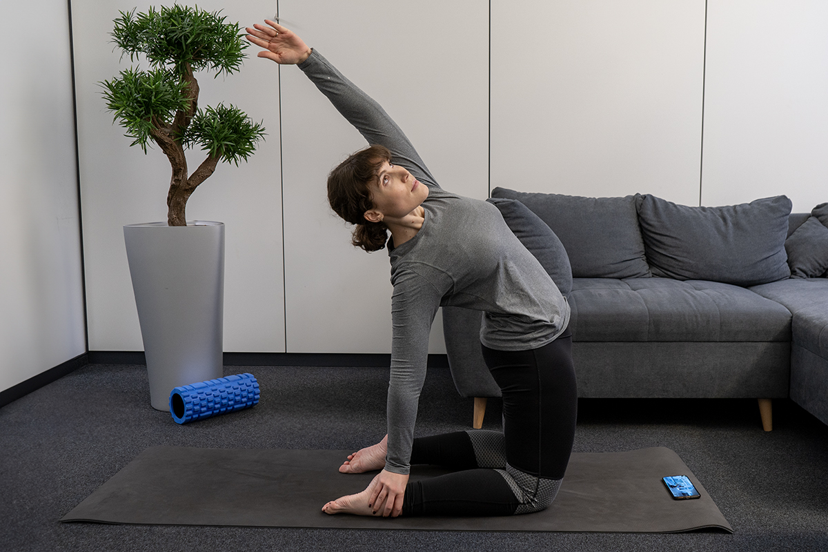 A woman does yoga exercises on the floor.