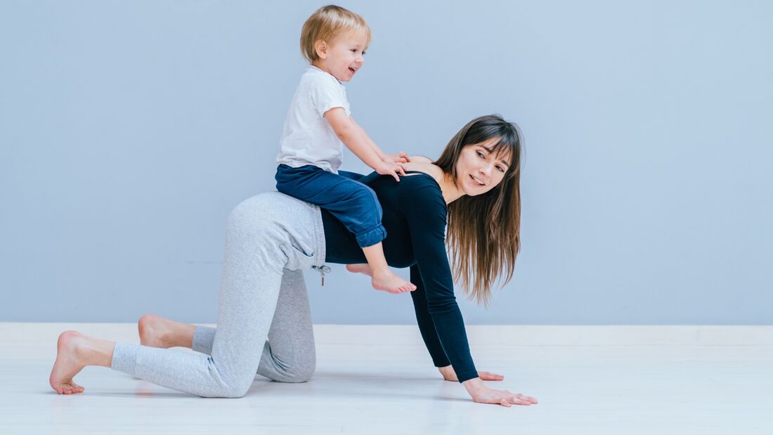 Mother crawling with her child on her back.