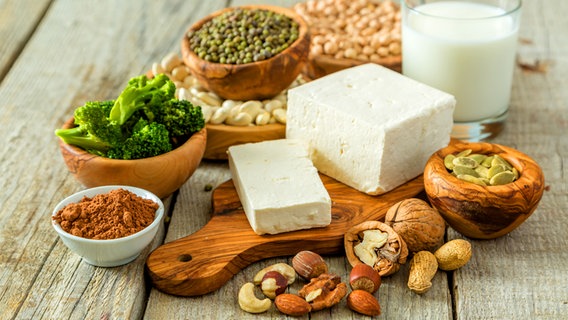 Nuts, tofu, soy milk, lentils, broccoli, beans on a table © Fotolia.com Photo: anaumenko