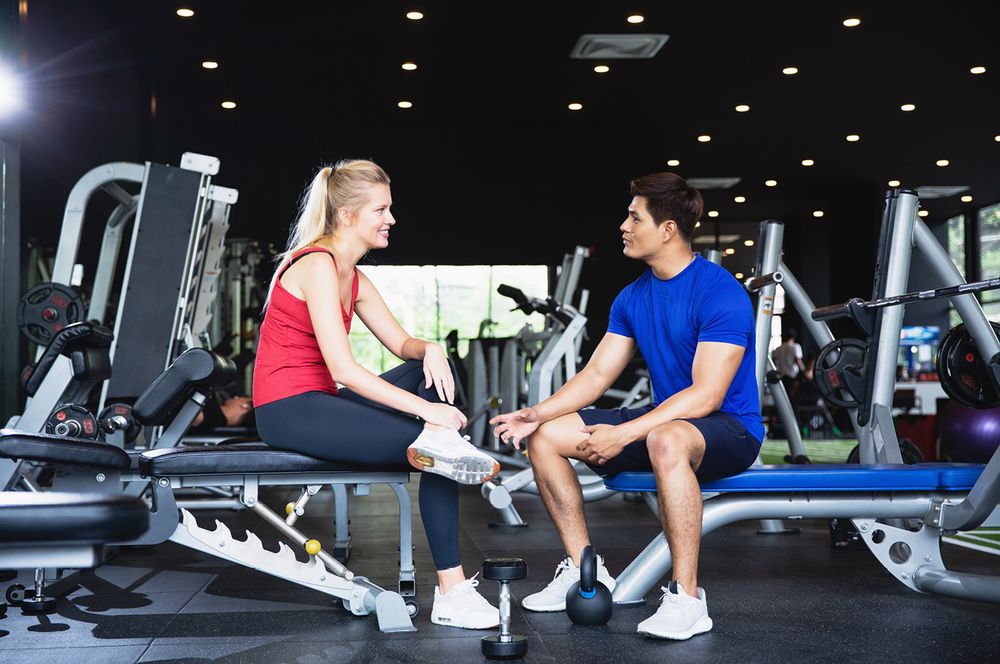 Trainer talking to a gym member